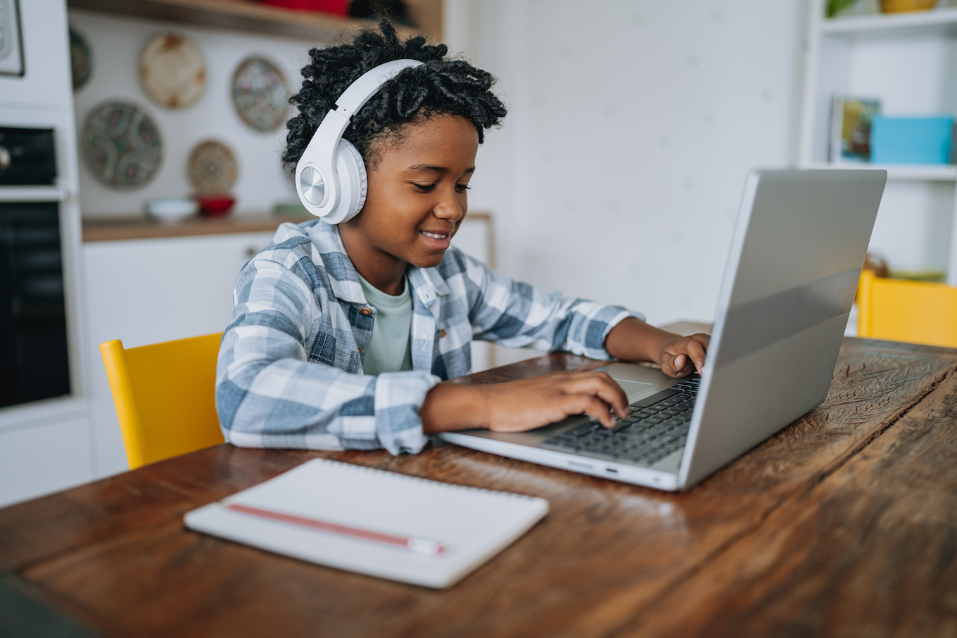 Portrait child boy studying at home on laptop